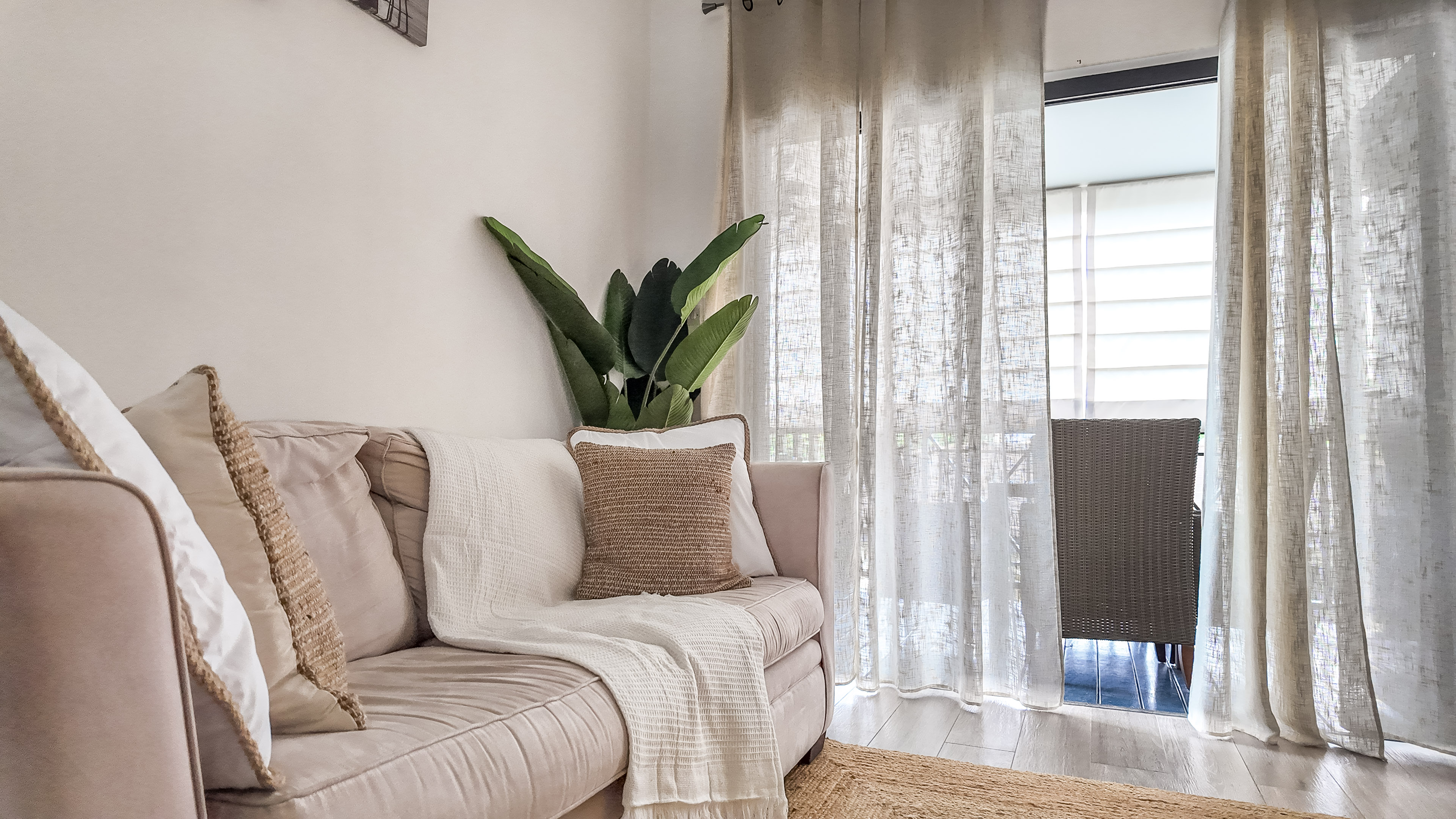 Bright, cozy lounge corner with balcony access and soft natural light