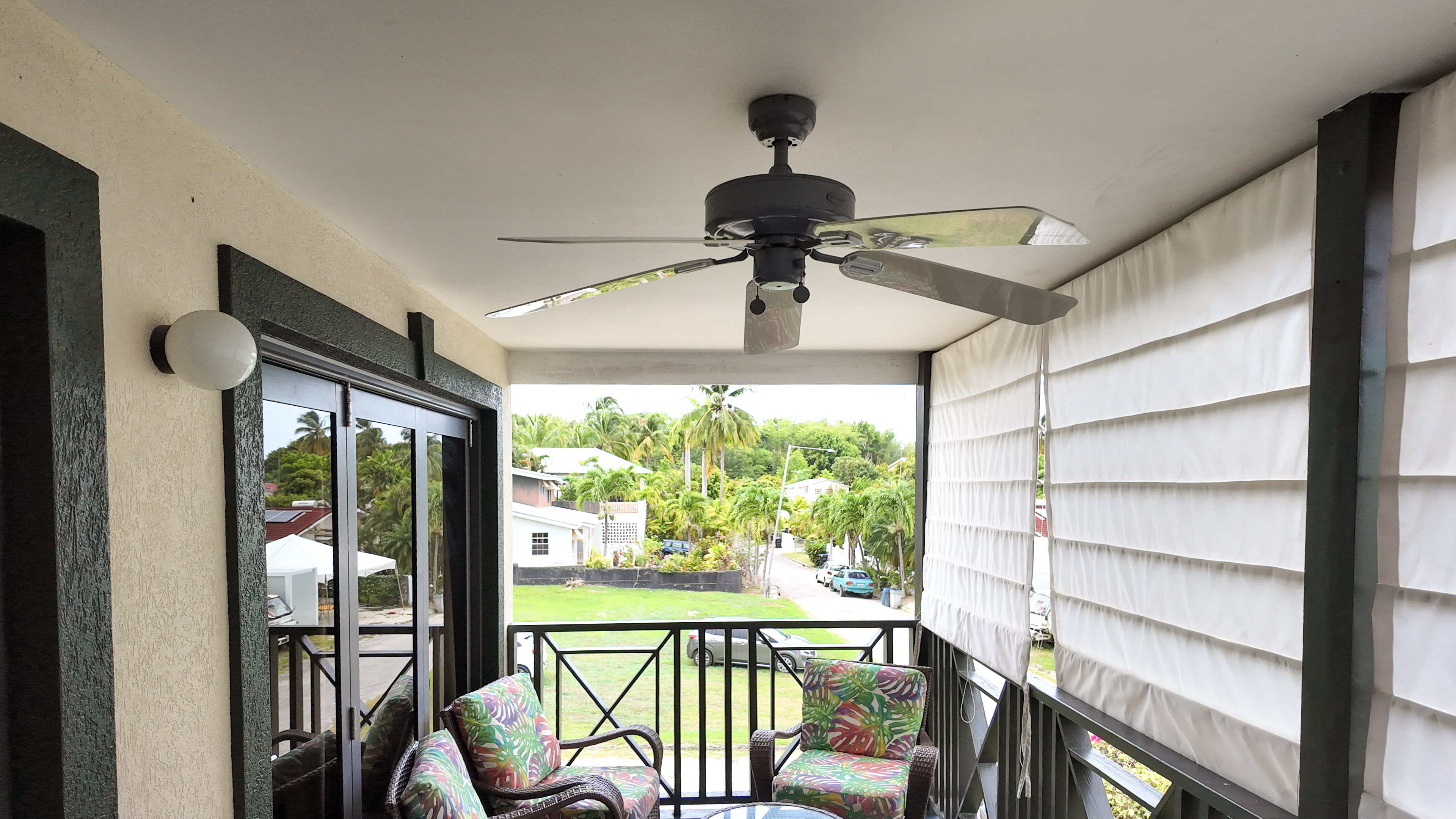 Private covered balcony with tropical views and breezy seating