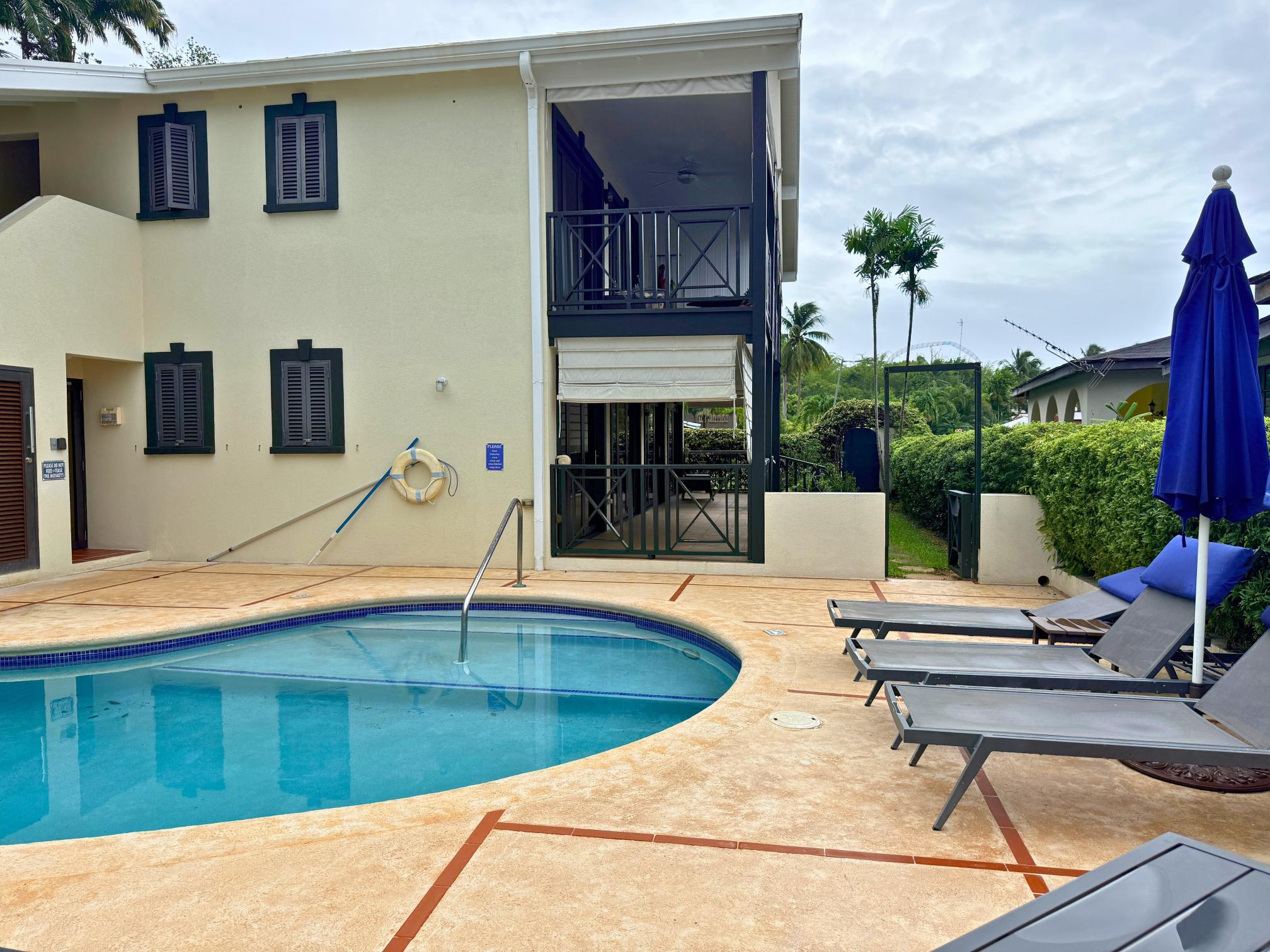 Private poolside villa with tropical charm, loungers, and a relaxing sun deck