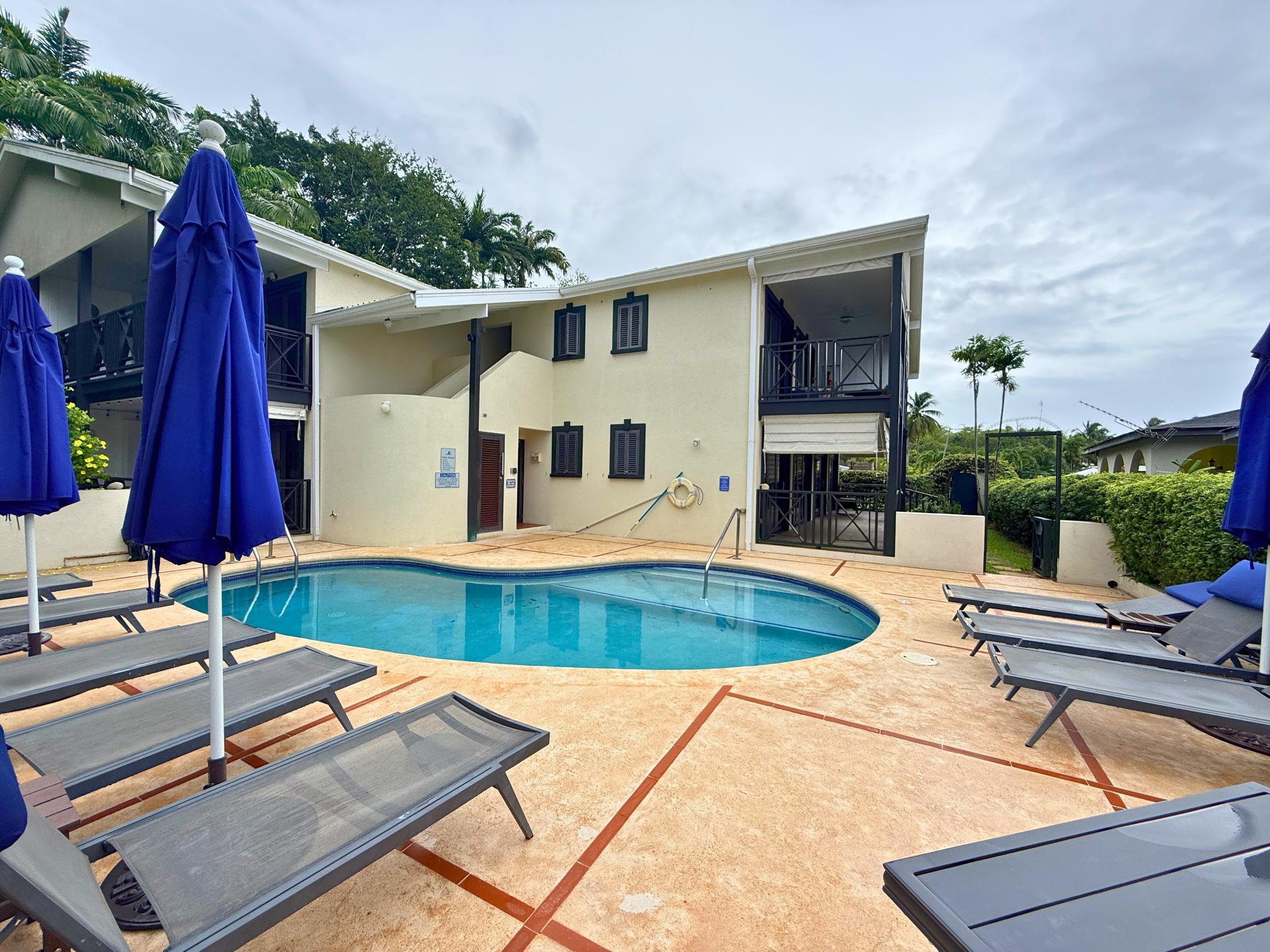 Relax by the tropical pool with loungers, umbrellas, and resort-style vibes