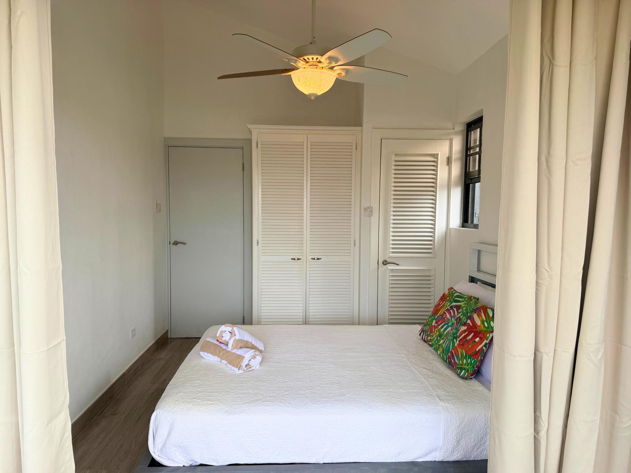 Bright minimalist bedroom with vaulted ceilings and built-in storage