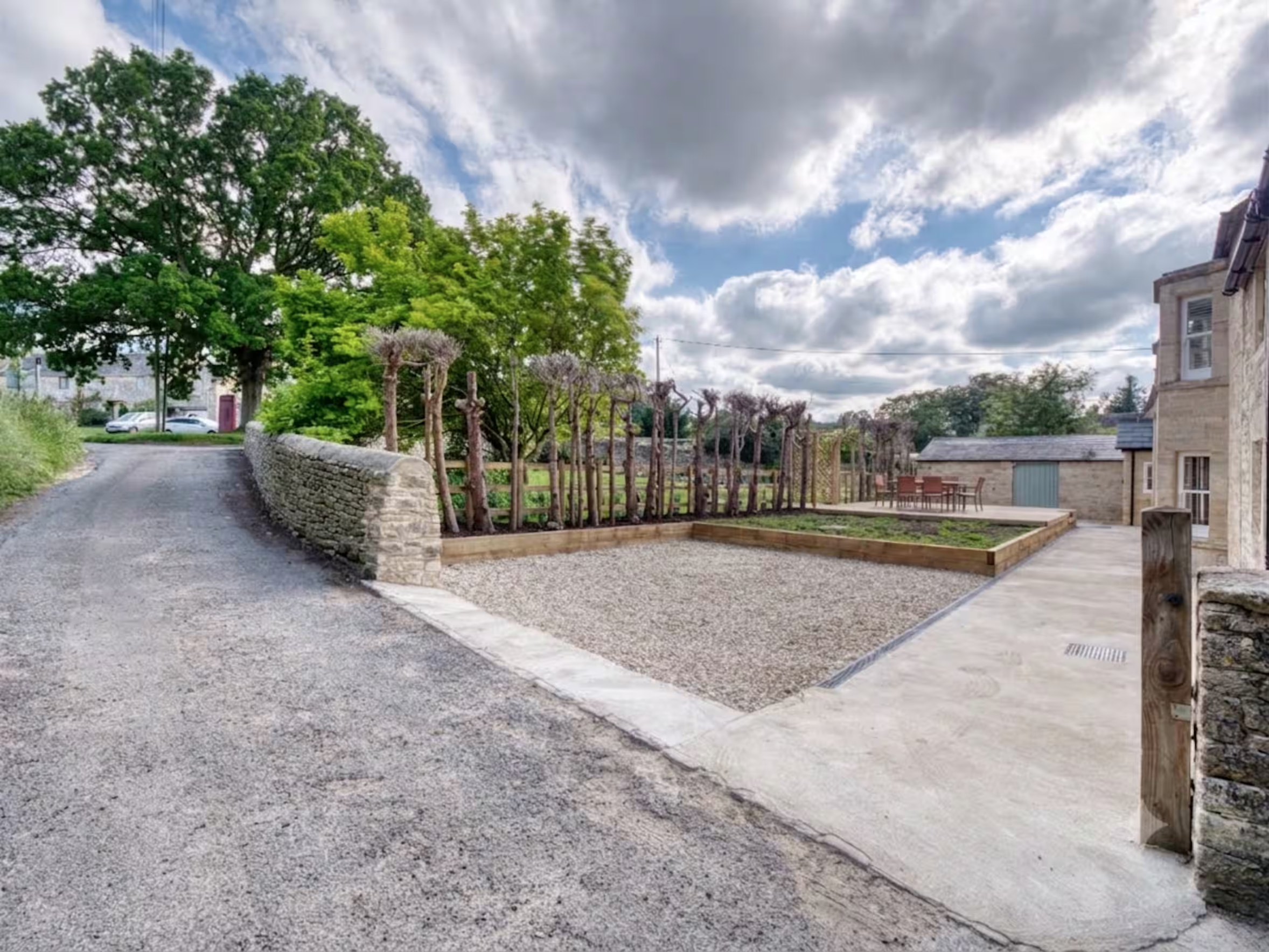 Spacious stone courtyard with landscaped grounds and easy parking