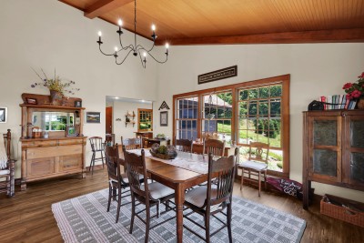 Gather for meals in this bright farmhouse dining room, with seating for 8 and lovely garden views — the perfect spot for shared mountain feasts and good company.