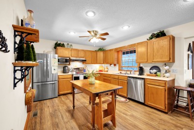Cook up something special in this warm, spacious kitchen, featuring stainless appliances and a charming island — the heart of the home for gathering and great meals.