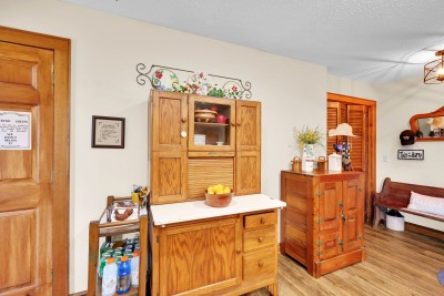 Step into this charming rustic entry, featuring vintage wood furnishings and cozy character — setting the tone for a warm mountain welcome from the moment you arrive.