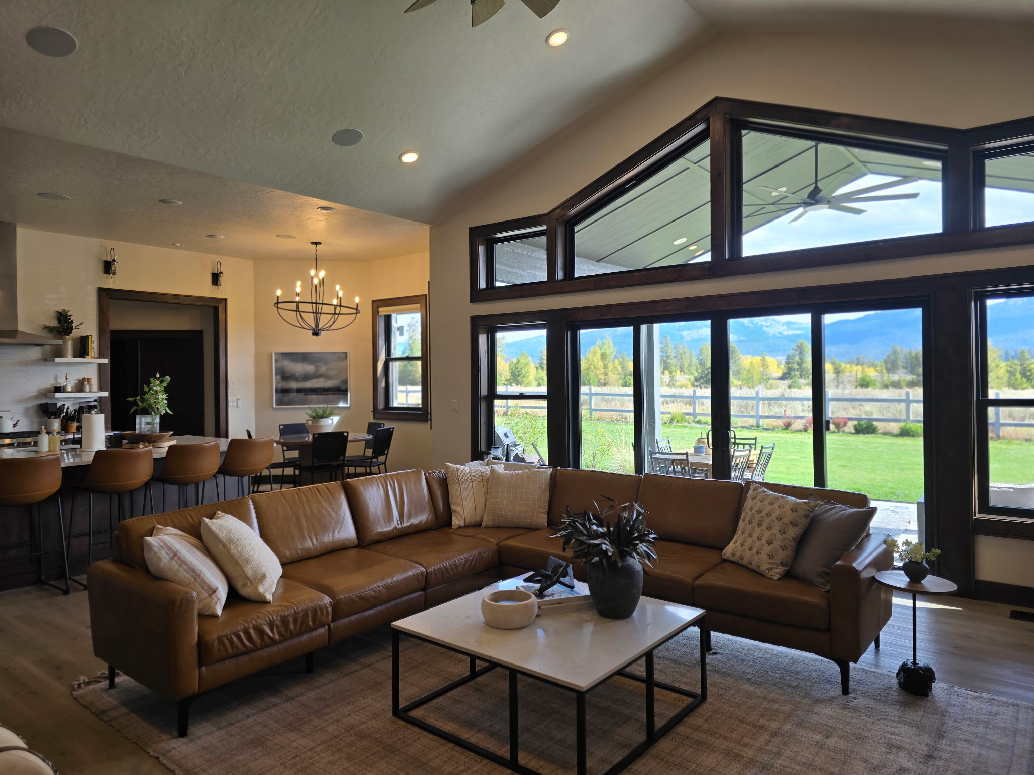 Bright open living space with mountain views and stunning floor-to-ceiling windows