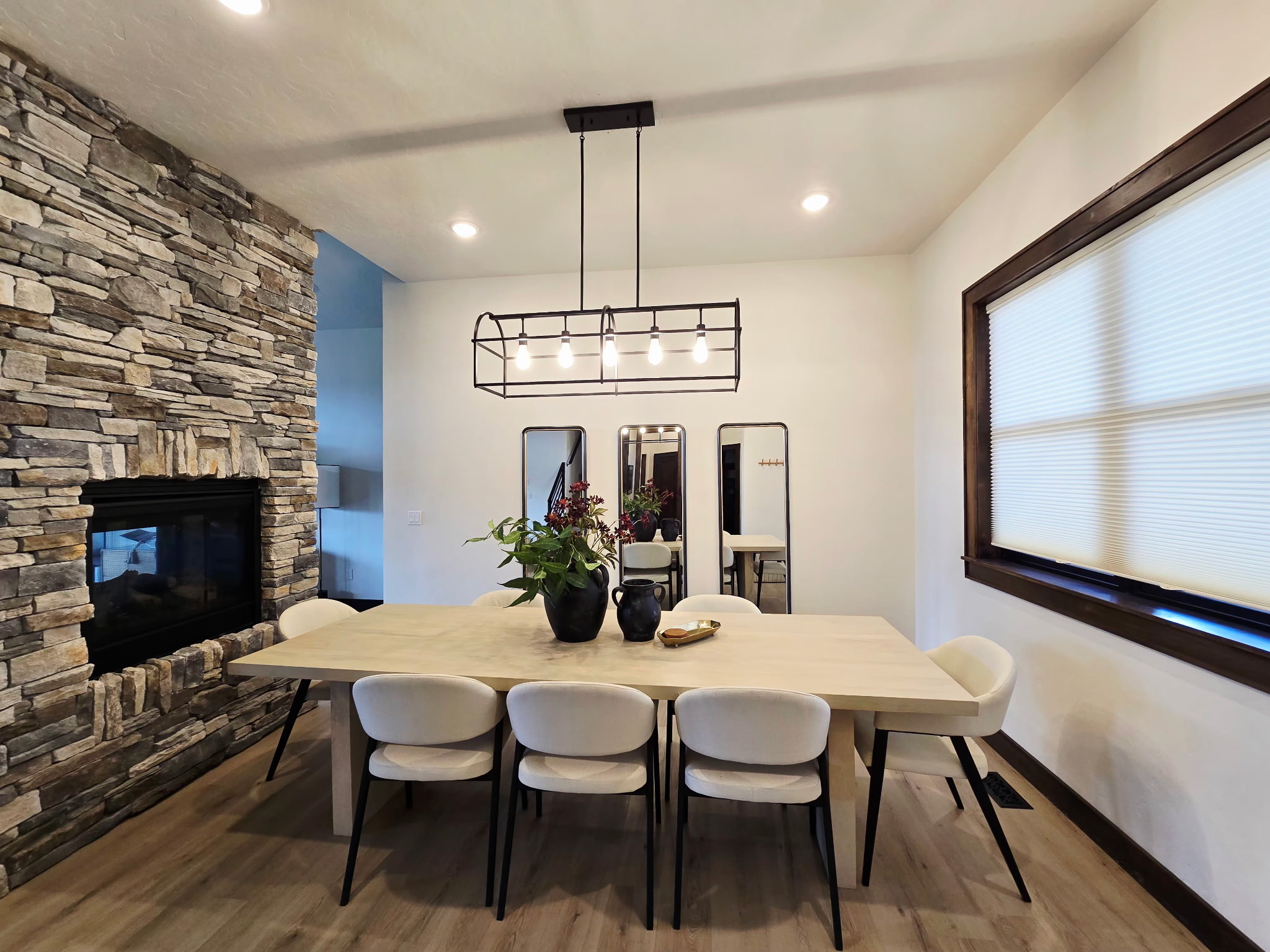 Modern dining room with seating for 6 and a stunning stone fireplace