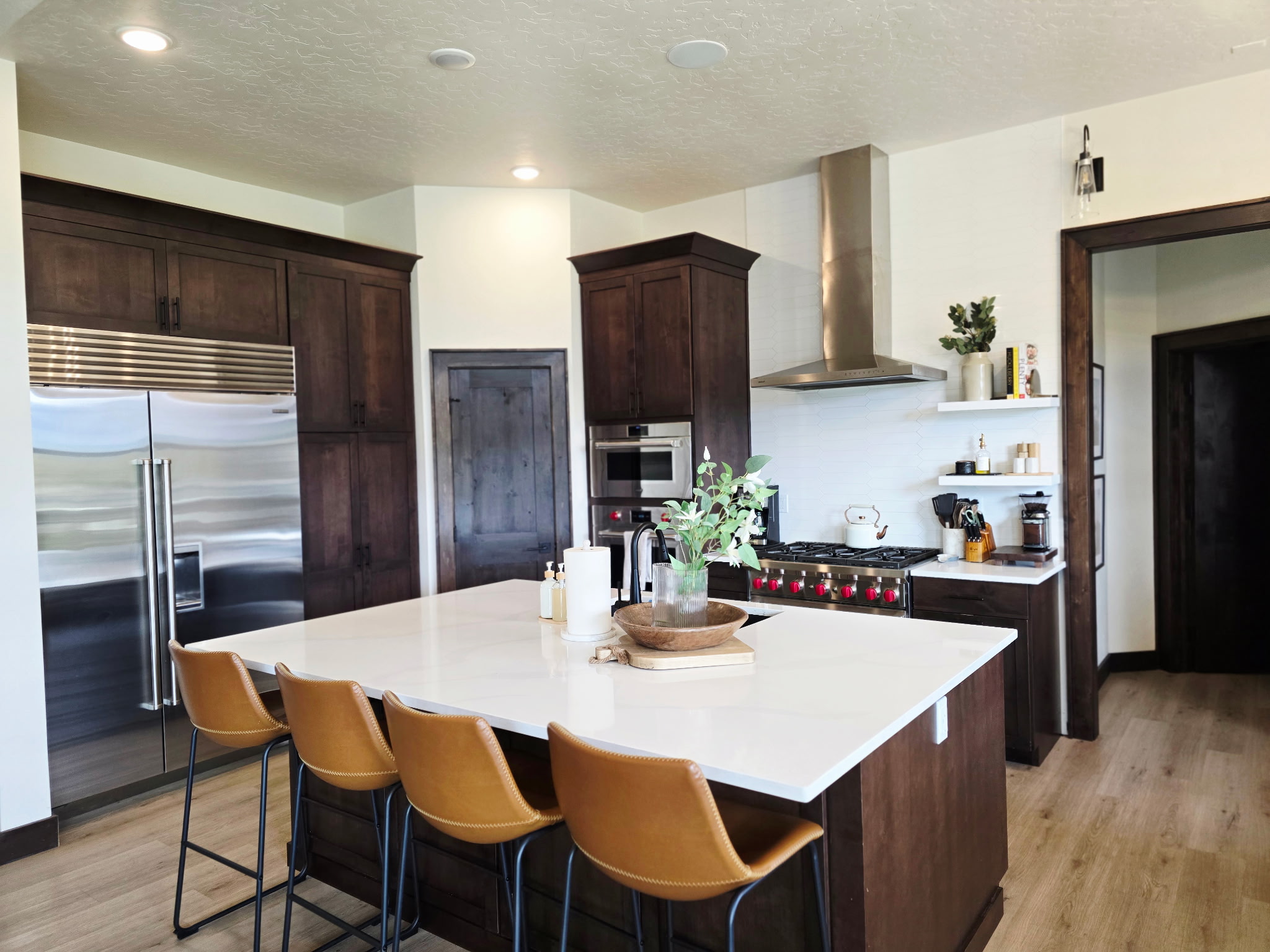 Spacious chef’s kitchen with waterfall island, bar seating, and premium appliances
