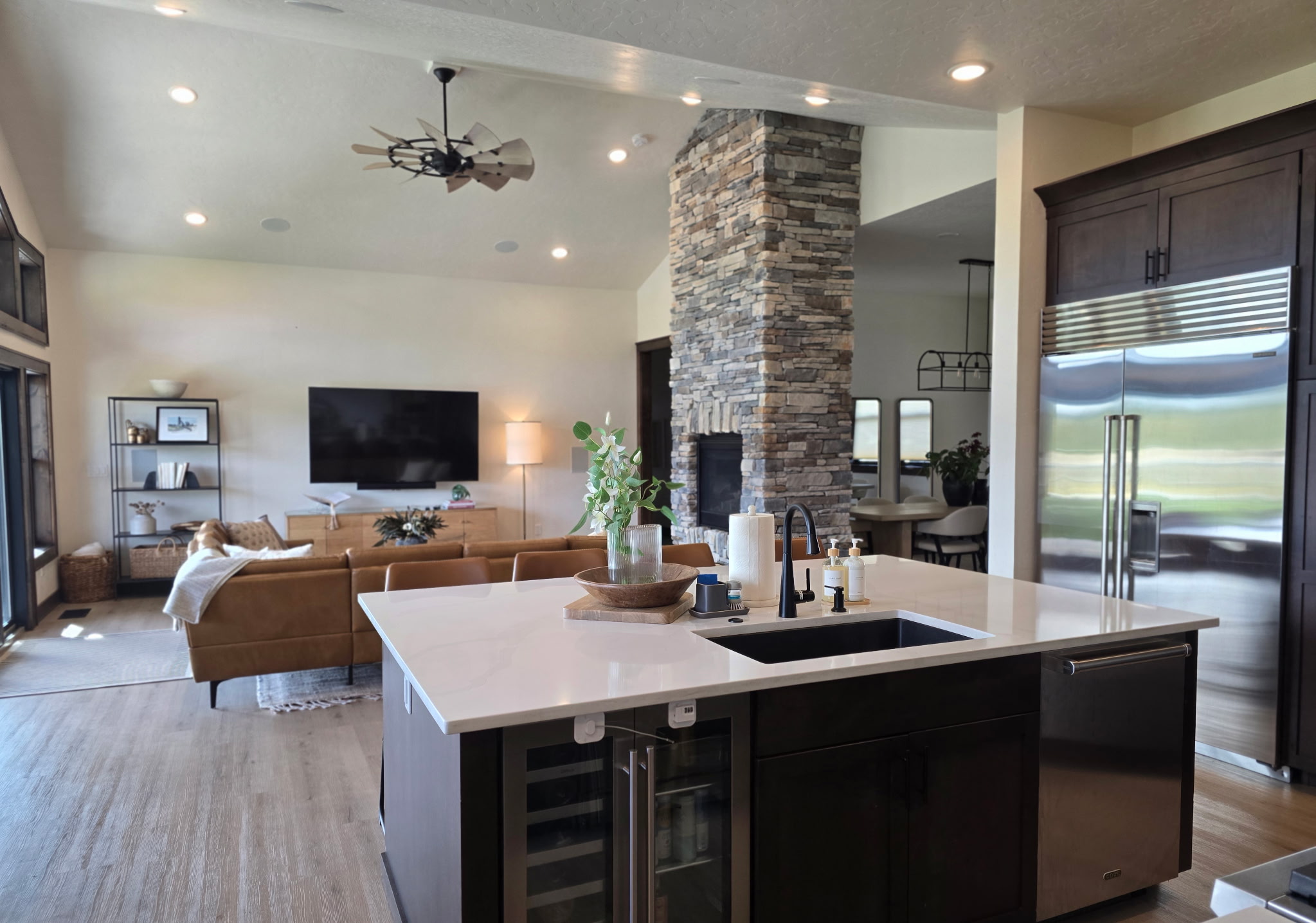 Spacious open living with chef’s kitchen and stunning stone fireplace