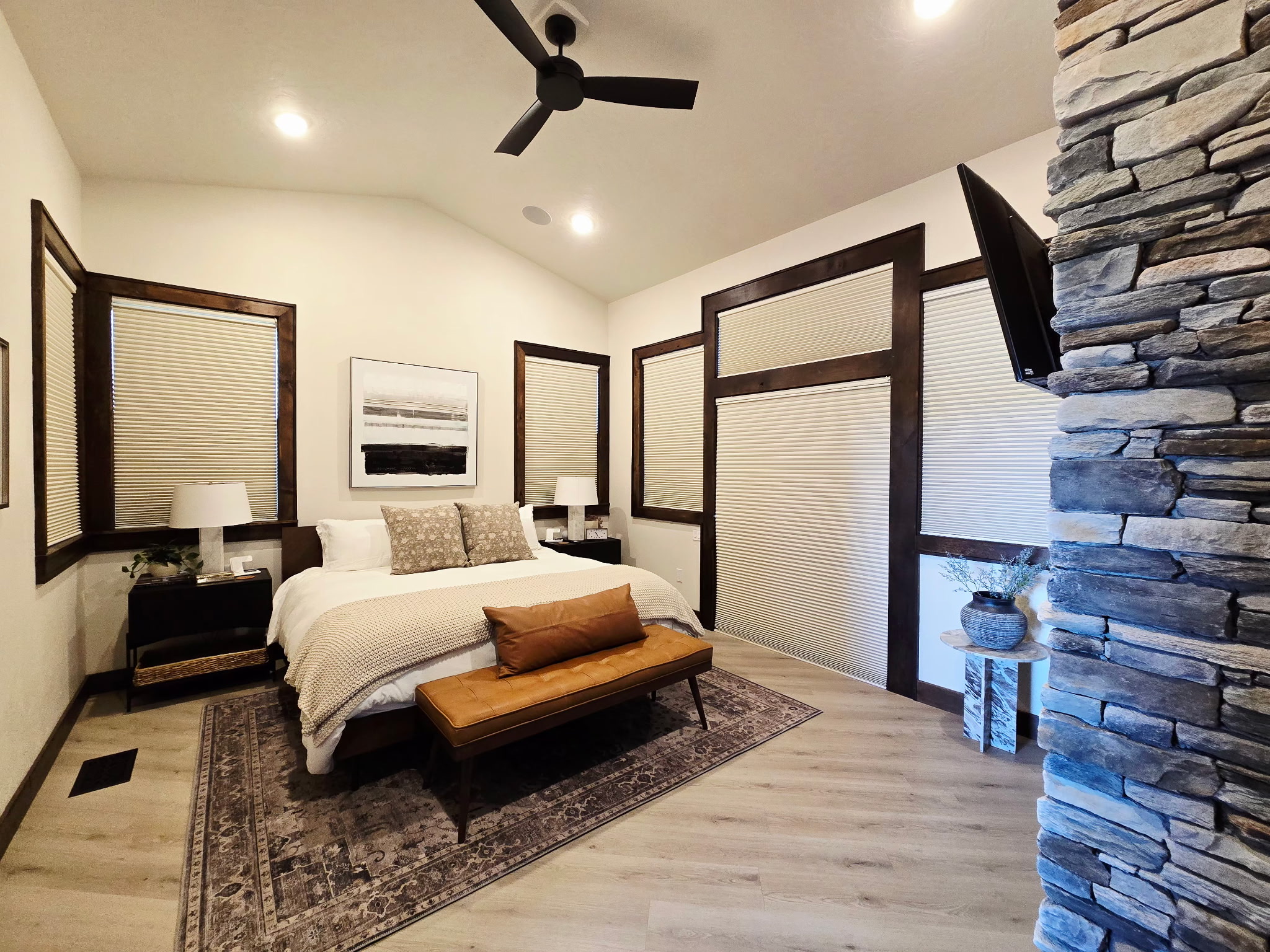 Spacious modern bedroom with stone accents and cozy designer touches
