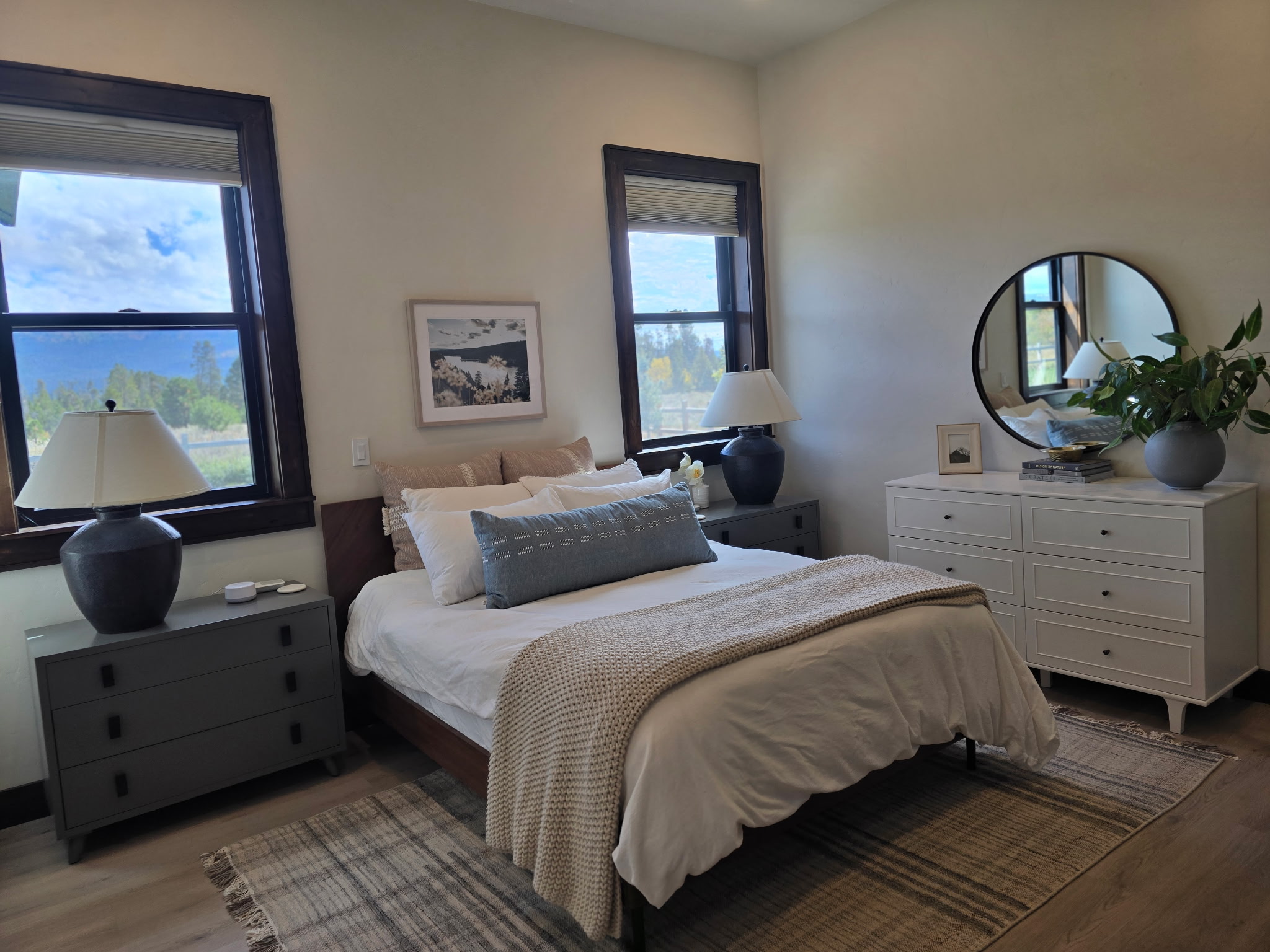 Bright, cozy bedroom with large windows and stylish modern decor