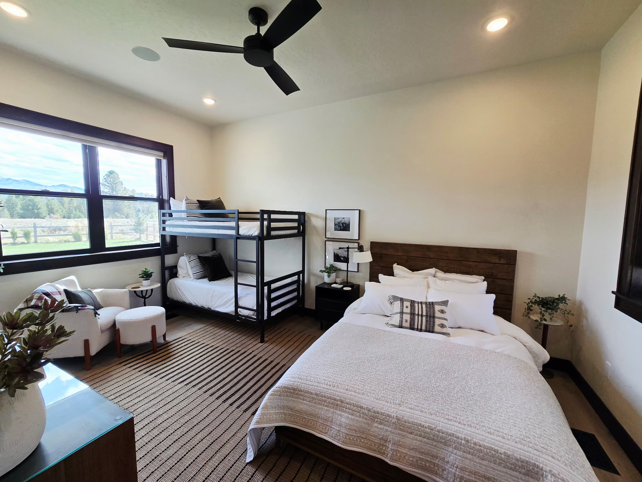 Bright family-friendly bedroom with bunk beds and scenic window views