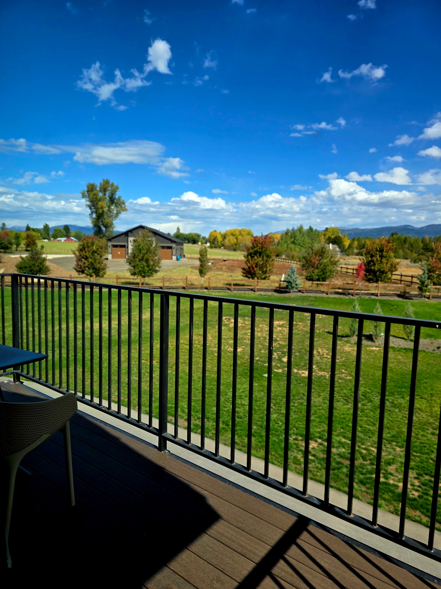 Scenic private deck with wide lawn, mountain views, and open skies
