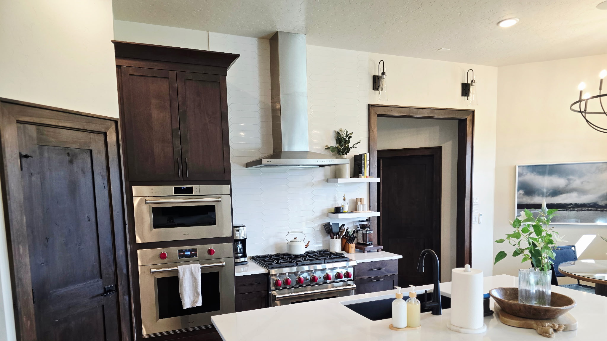 Upscale chef’s kitchen with island, gas range, and custom wood cabinetry
