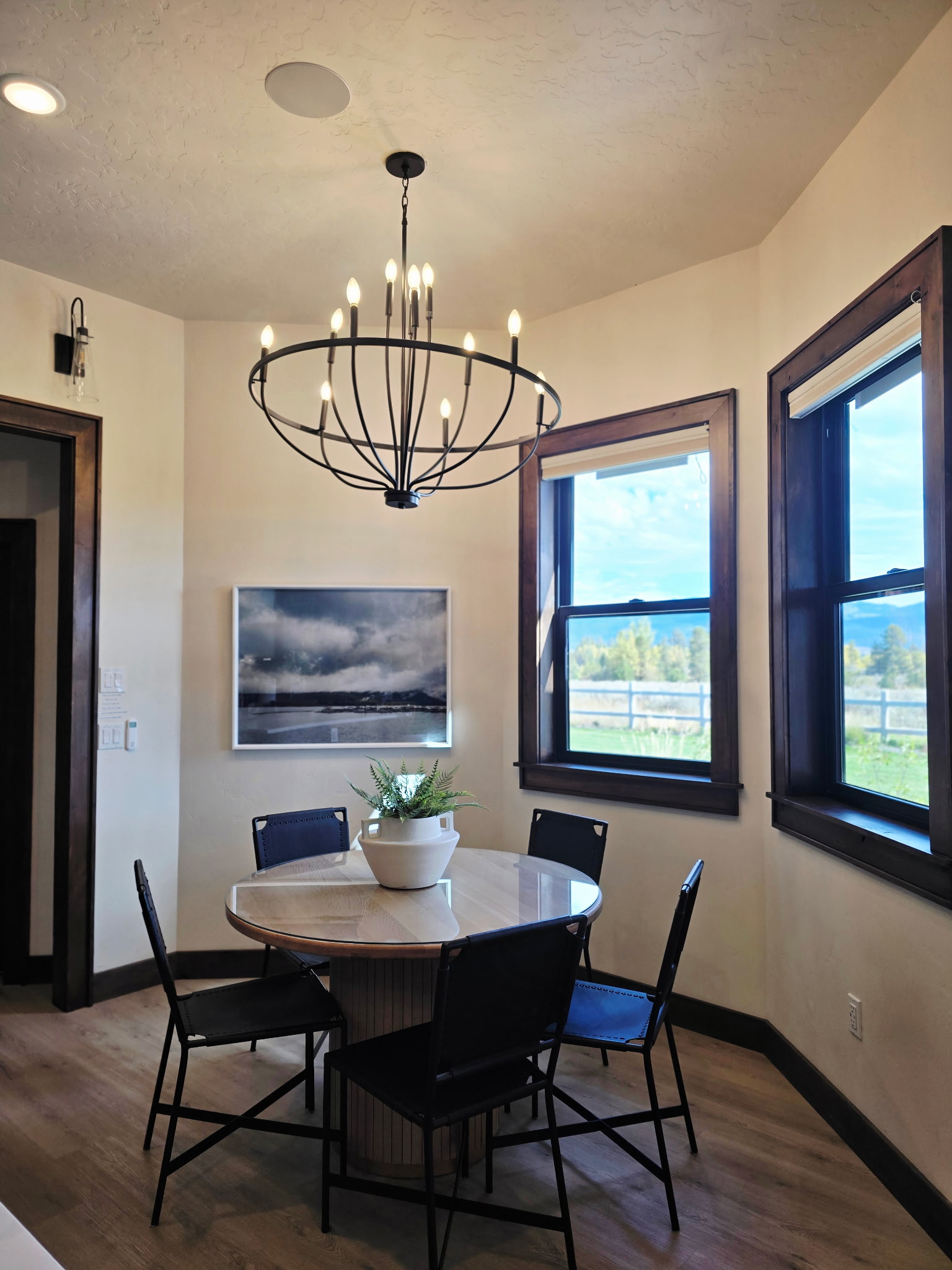 Bright dining nook with scenic views and a stylish modern chandelier