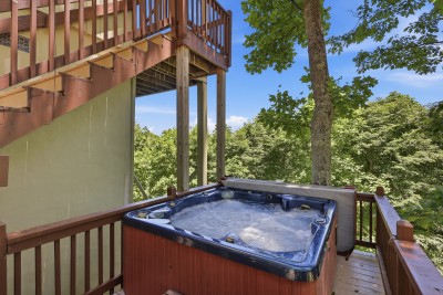 Sink into the private outdoor hot tub and let the jets melt away the day as peaceful treetop views and fresh mountain air surround you — pure relaxation on your own secluded wooded deck.