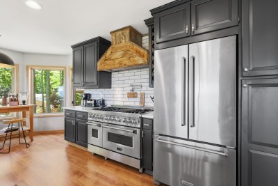 The chef-style kitchen at Beech Mountain High is fully equipped and beautifully lit — premium appliances and an abundance of natural light make cooking for the whole group as enjoyable as the meals themselves.