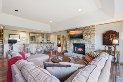 The family room is built for togetherness — featuring a stunning stone fireplace, mountain-style character, and spacious seating that comfortably brings the whole group together after a day of adventure.