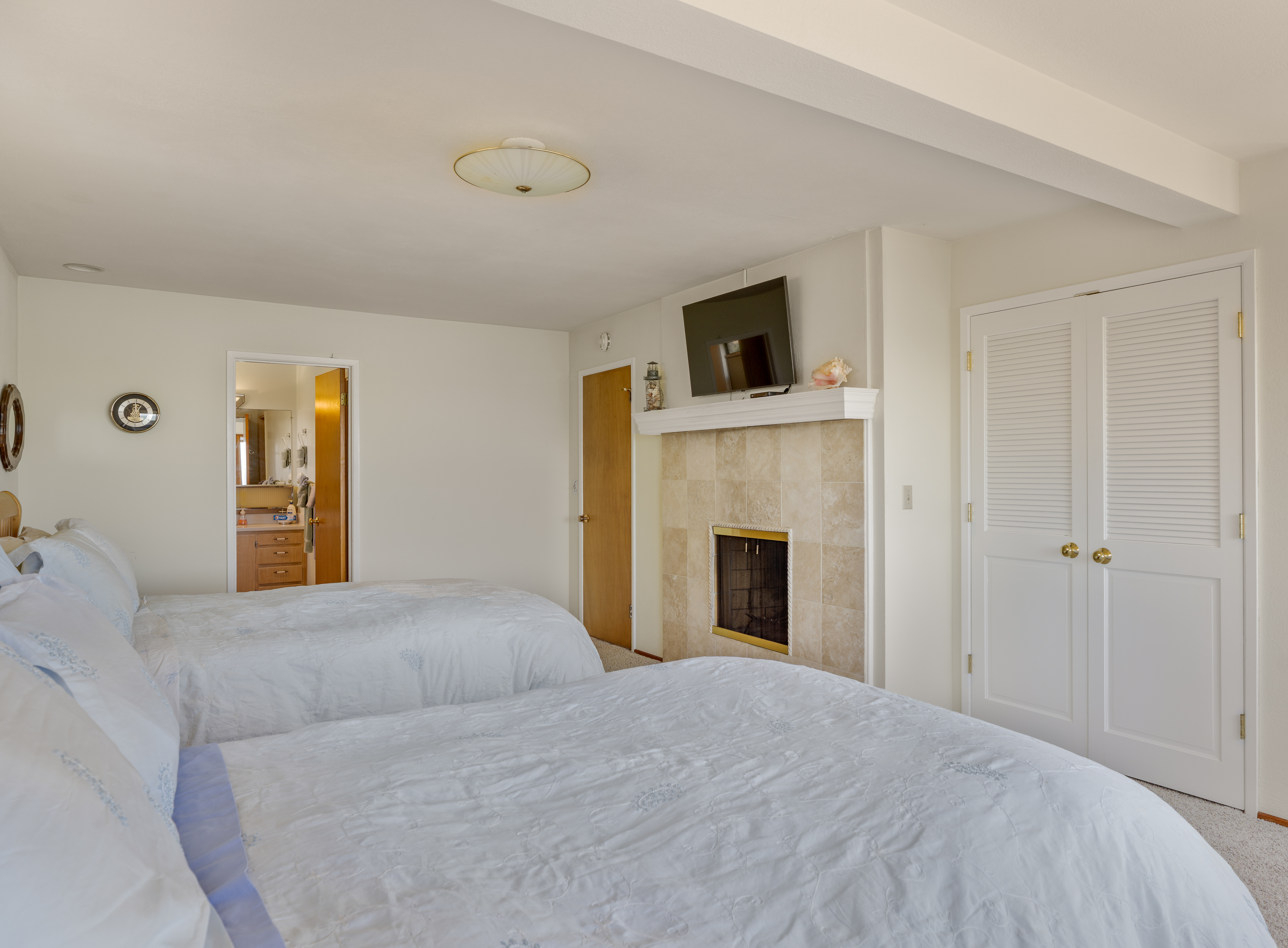 Bright double bedroom with fireplace, TV, and en suite bathroom