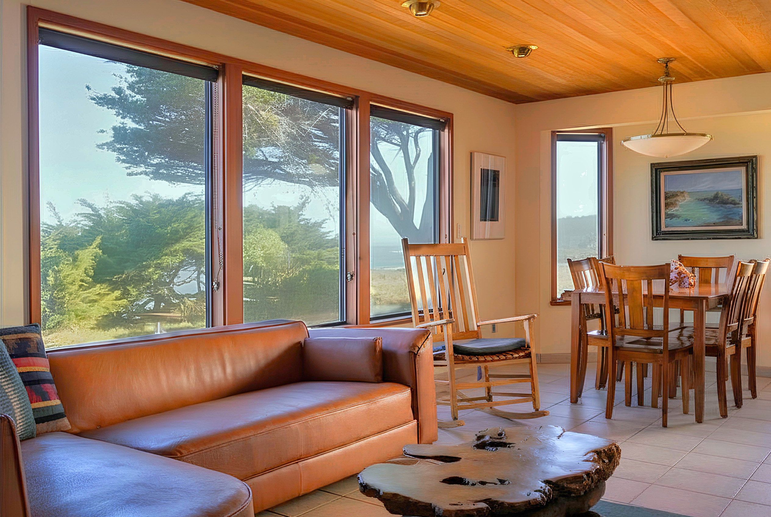 Sunlit living space with ocean-view windows and warm wood accents