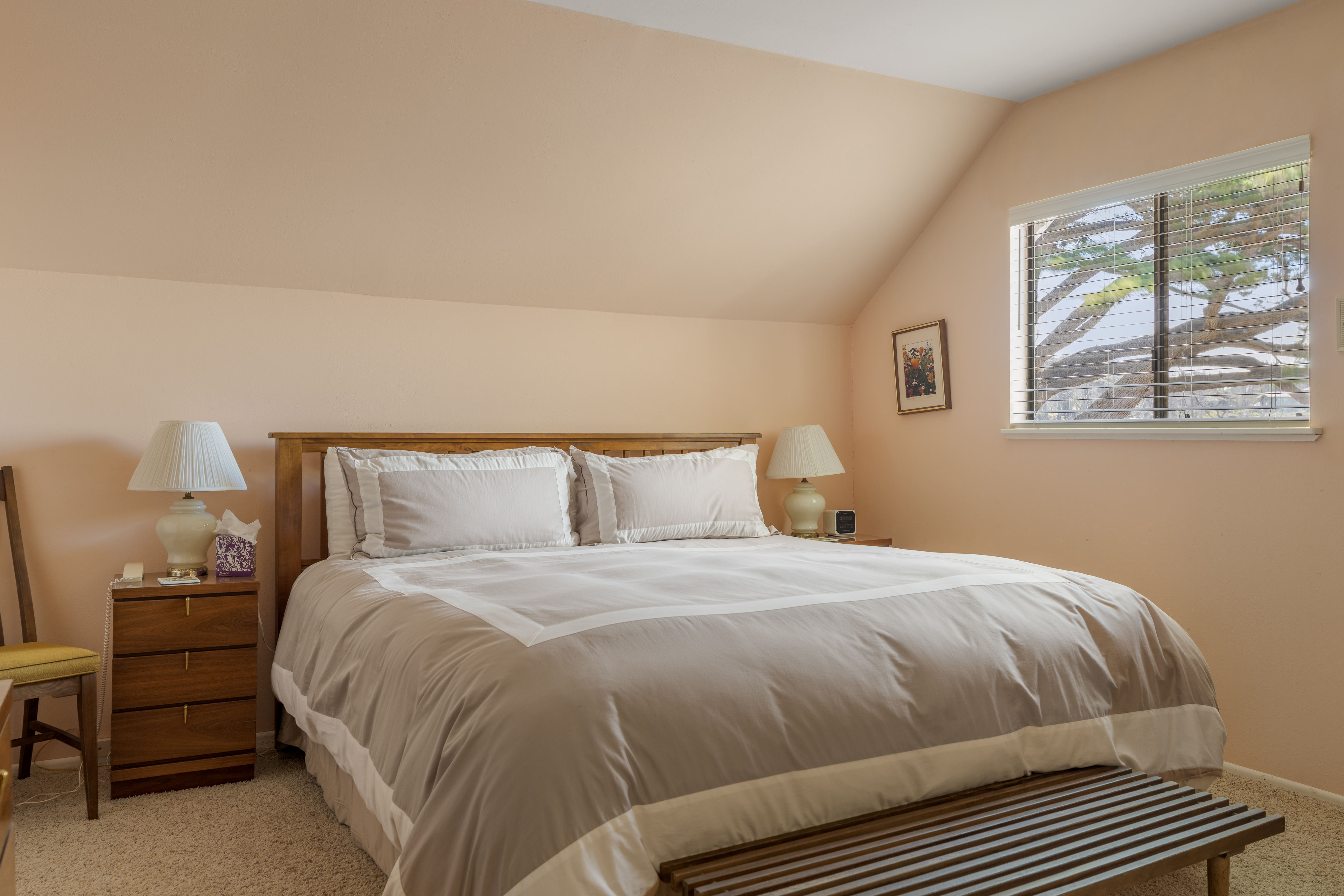 Bright, cozy bedroom with plush king bed and warm natural light