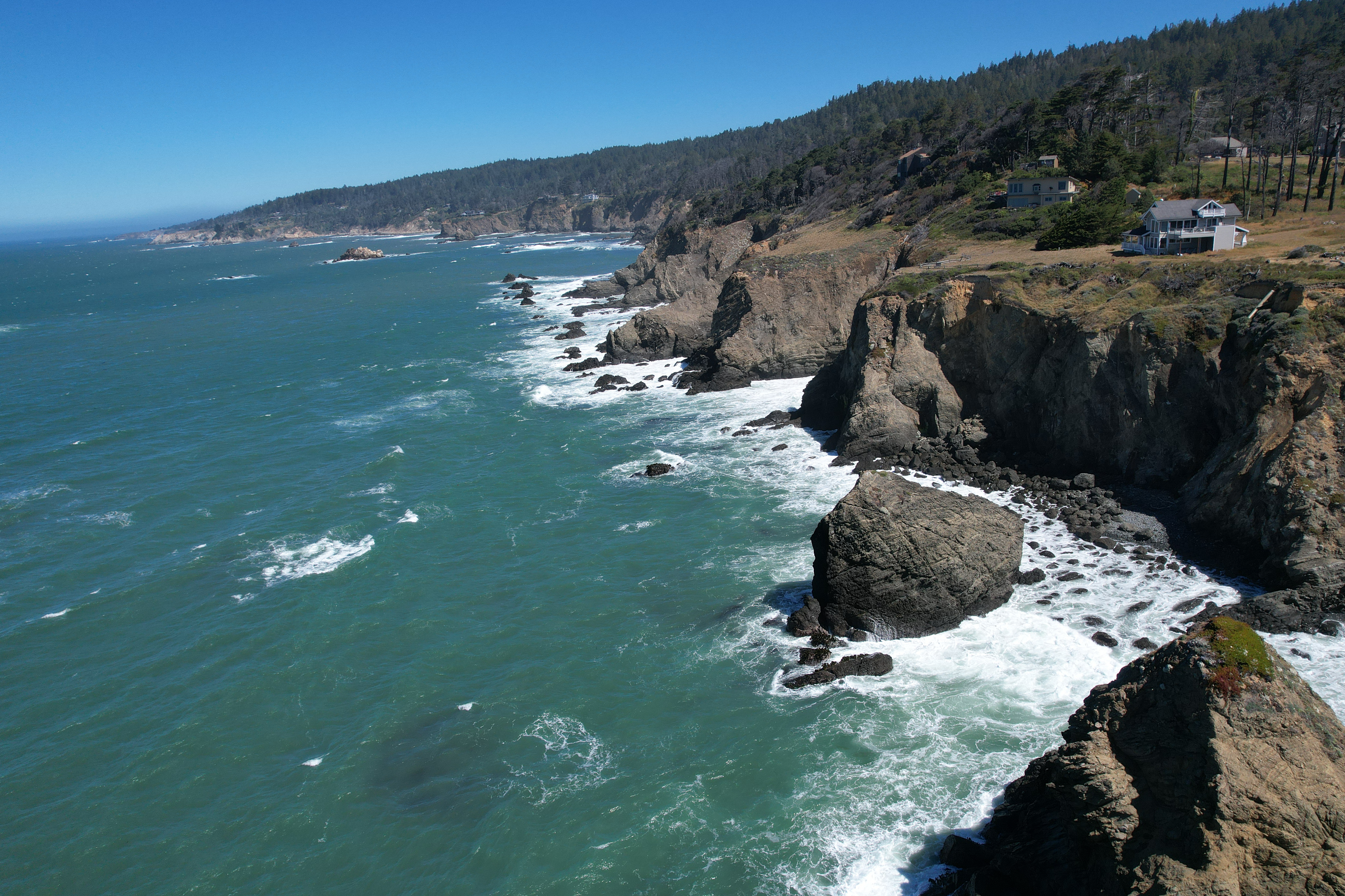 Dramatic cliffside ocean views with rugged coastline and crashing waves
