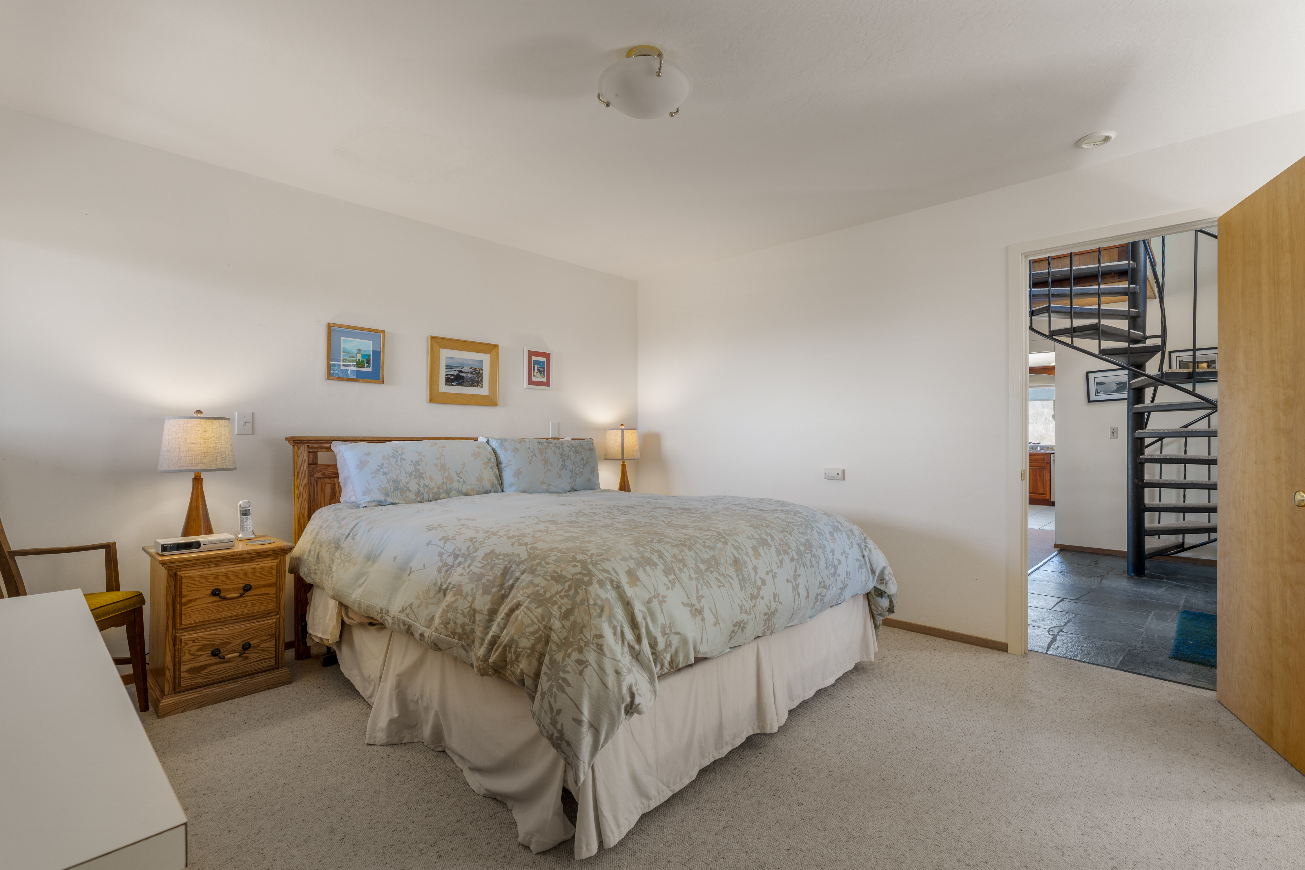Bright, spacious bedroom with cozy lighting and a large inviting bed