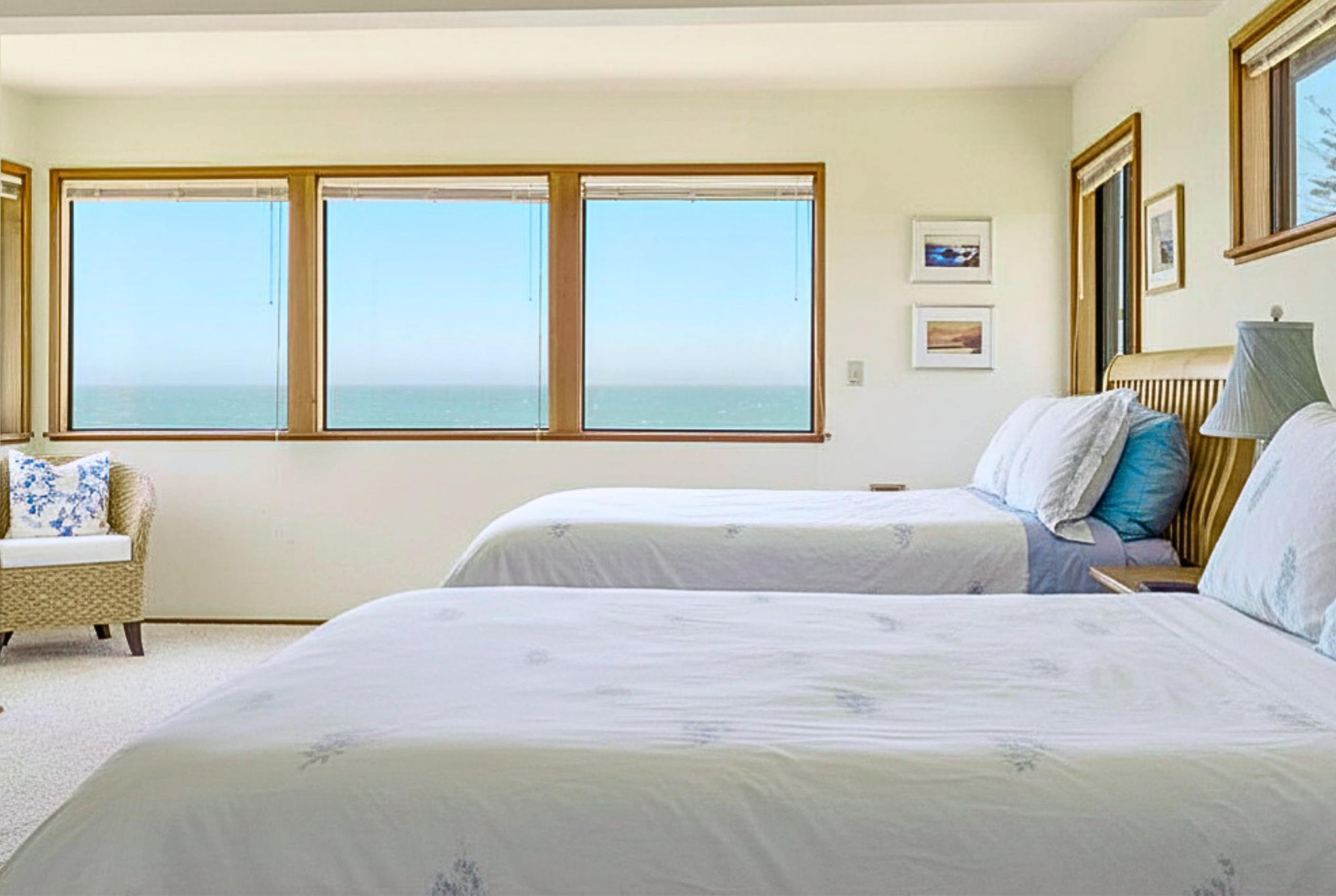 Bright double bedroom with sweeping ocean views and a calm coastal feel