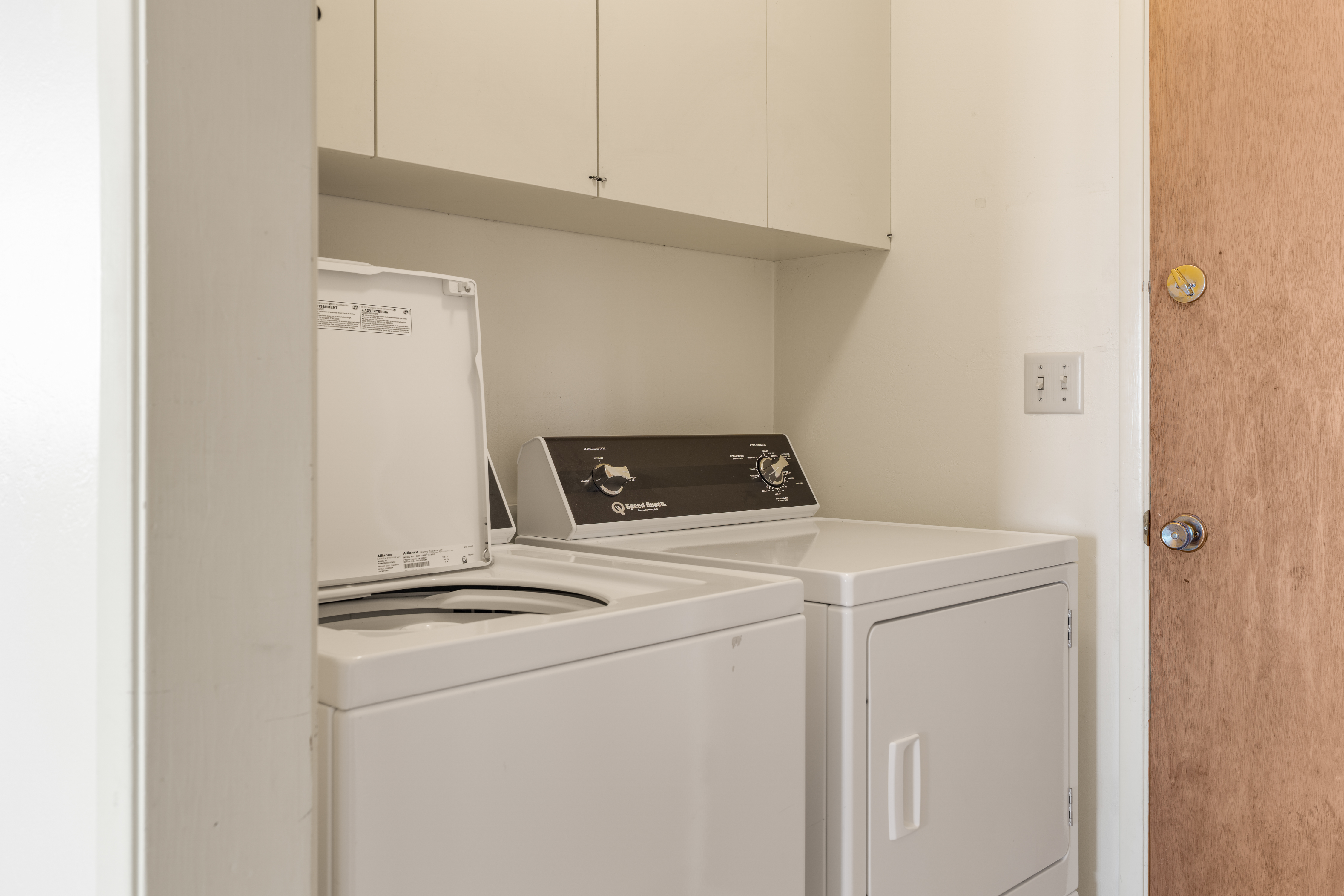 Convenient in-unit washer and dryer with extra storage above