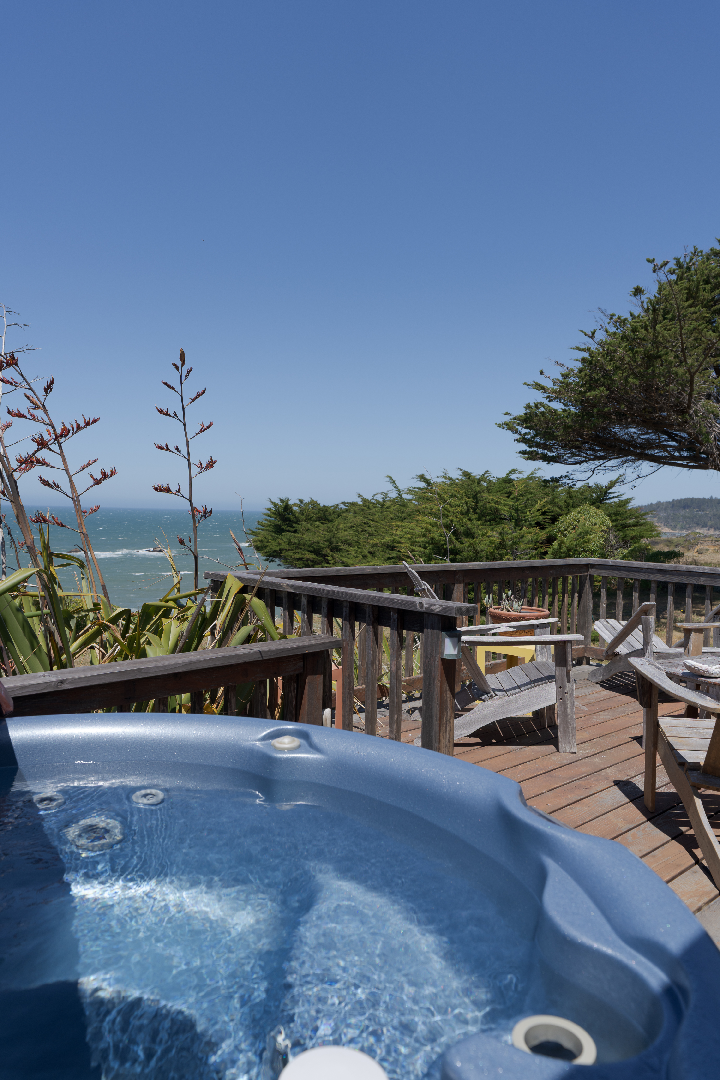 Ocean-view deck with private hot tub and relaxing outdoor seating