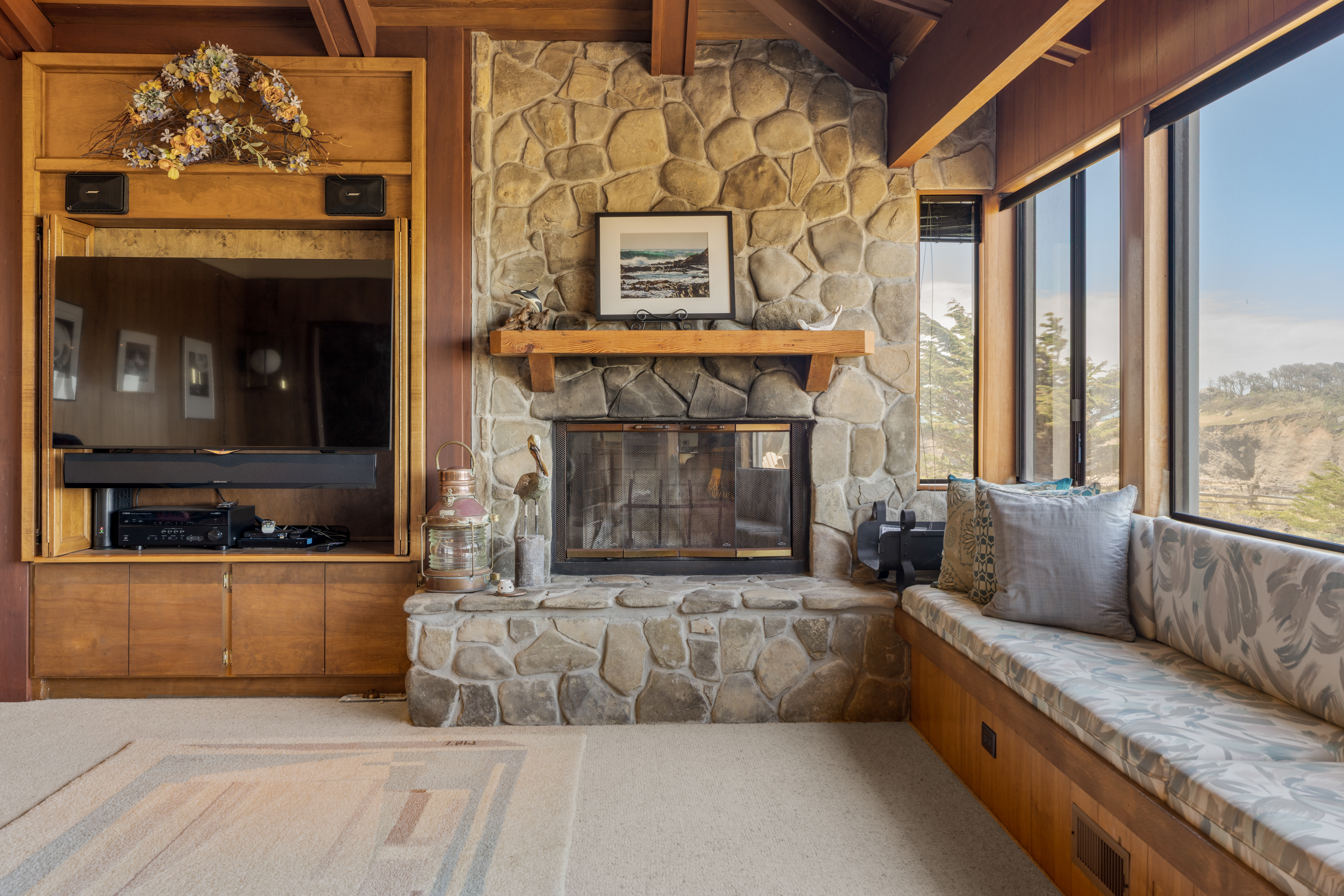 Cozy stone fireplace lounge with window seating and scenic views