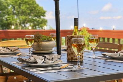 The private deck dining area at Beech Mountain Place is made for unwinding — pour a glass of wine and let the peaceful wooded views set the scene for an unforgettable evening surrounded by nature.
