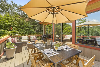 The private tree-lined deck at Beech Mountain Place is an outdoor living dream — generous dining space, comfortable lounge seating, and a ready-to-use grill create the perfect setting for memorable meals surrounded by nature.