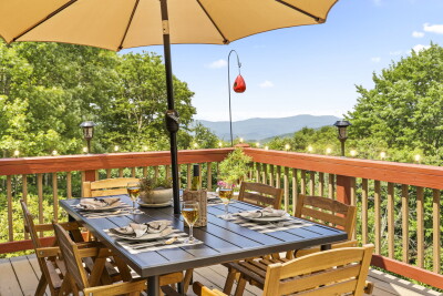 Dine in the shade on the scenic mountain-view deck — seating for four and breathtaking views make every meal outdoors at Beech Mountain Place a memorable experience.