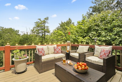 String lights twinkle overhead on the private wooded deck — comfortable seating and a warm, inviting ambiance make this peaceful outdoor space at Beech Mountain Place perfect for evening relaxation.