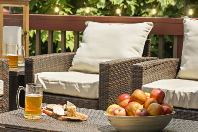The outdoor deck invites you to unwind — plush cushioned seating and a warm, inviting evening ambiance create the perfect setting to relax and soak in the peaceful surroundings at Beech Mountain Place.