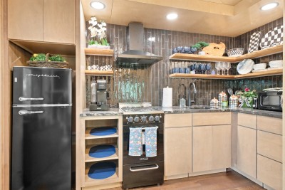 Whip up mountain memories in this stylish modern kitchen, featuring a fun retro fridge, open shelving, and everything you need to cook up a feast.