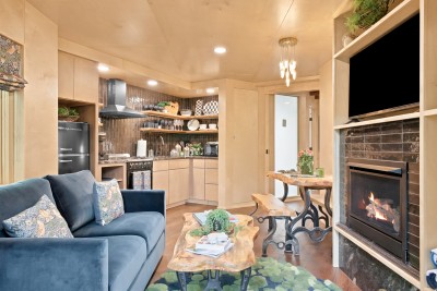 Discover this architectural forest retreat, featuring a striking elevated entry and a rooftop deck that puts the surrounding mountain views on full display.