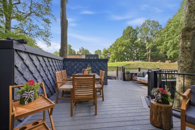 Gather on this spacious tree-lined deck, made for outdoor dining and cozy lounge seating — the perfect spot to soak in the fresh mountain air with family and friends.