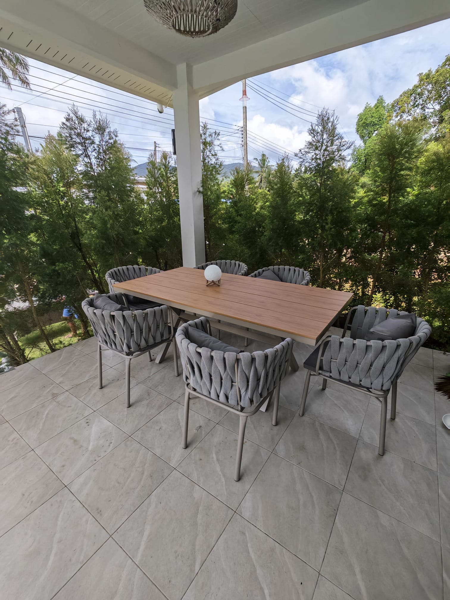 Covered garden-view patio with stylish outdoor dining for six