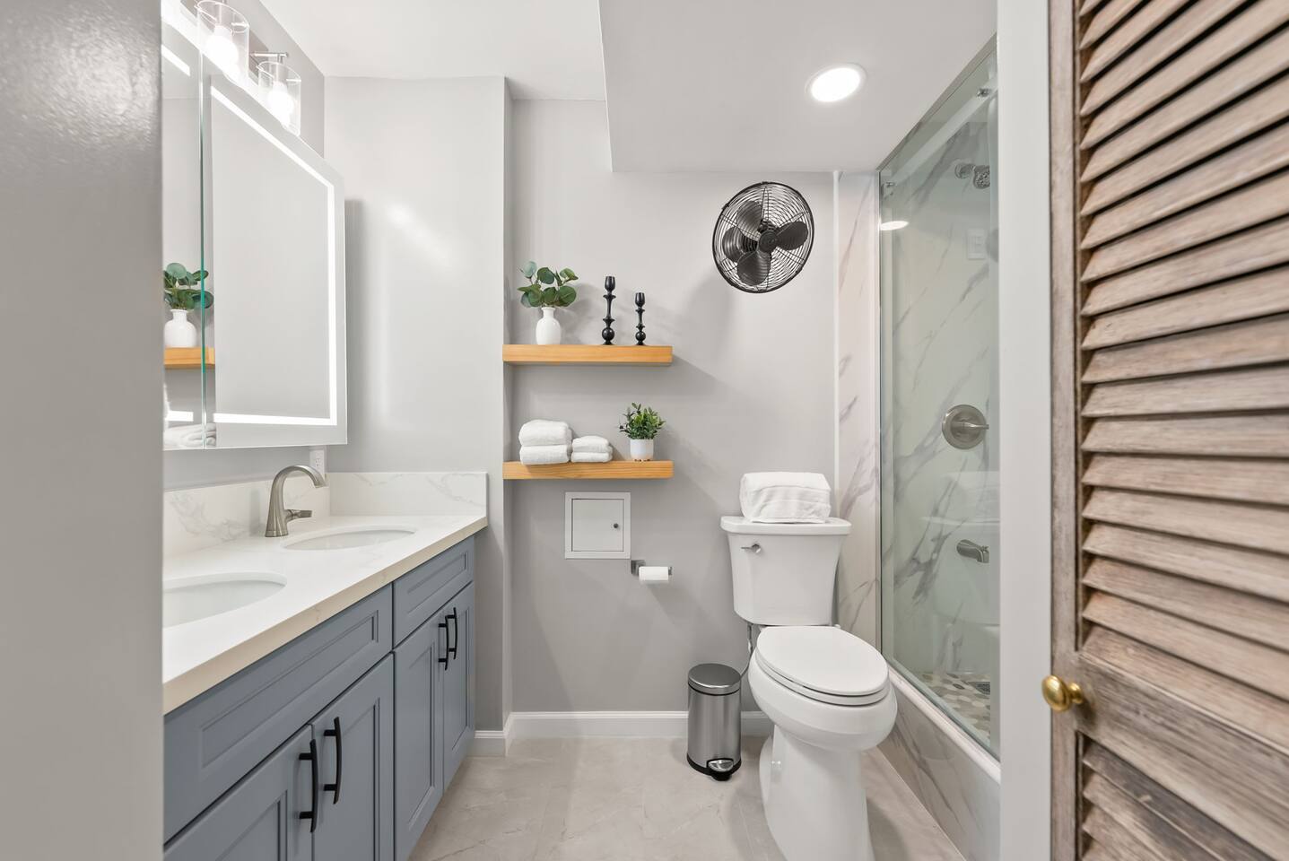 Featuring a full bath with a double sink vanity and walk-in shower.