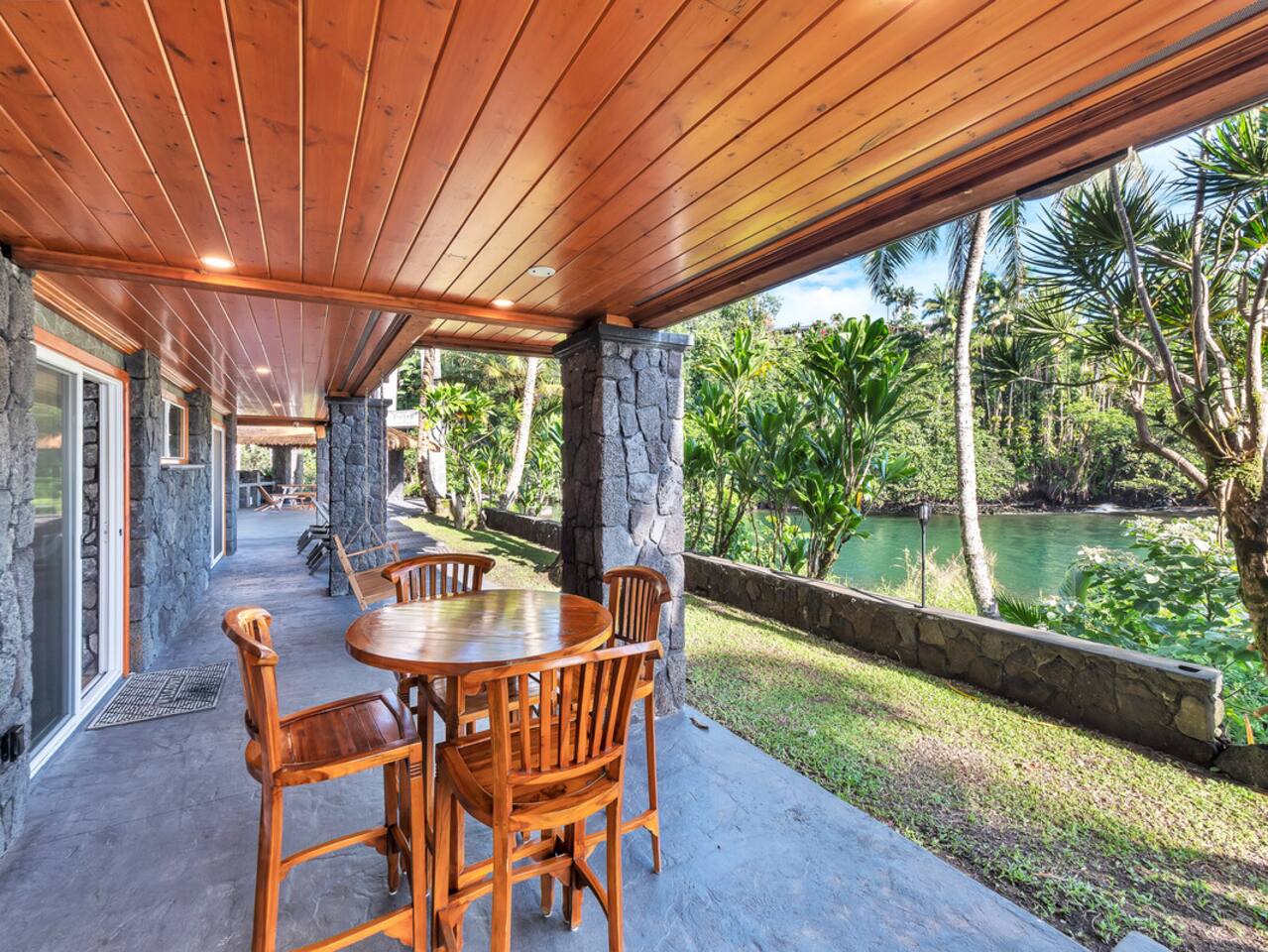 The spacious wrap-around lanai invites you to find your perfect spot, whether you're lounging in a cozy nook or enjoying a meal at the outdoor table for four.