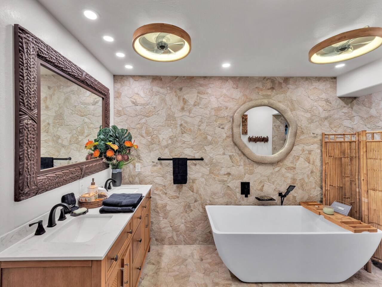 Freshen up in the downstairs full bath, complete with a double vanity, soaker tub, and custom shower with stunning lava rock accents.