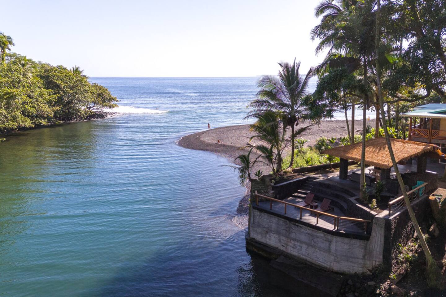 Bask in the beauty of Hawaii with a front-row seat to where the river meets the waves at this pristine oceanfront estate.