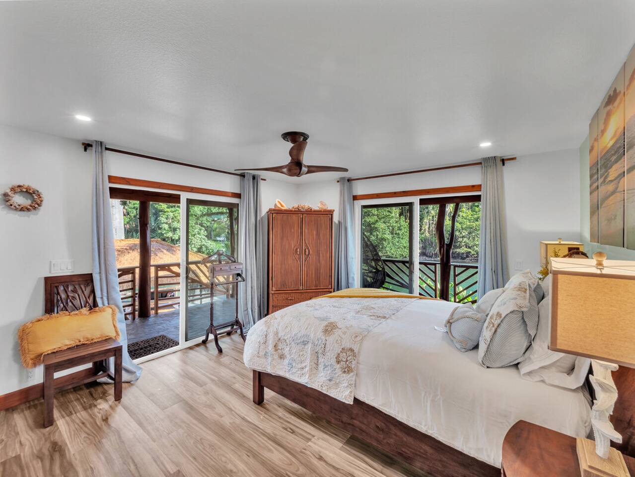 Unwind in this nautical-themed master bedroom, where ocean and stream views create the perfect backdrop for rest.