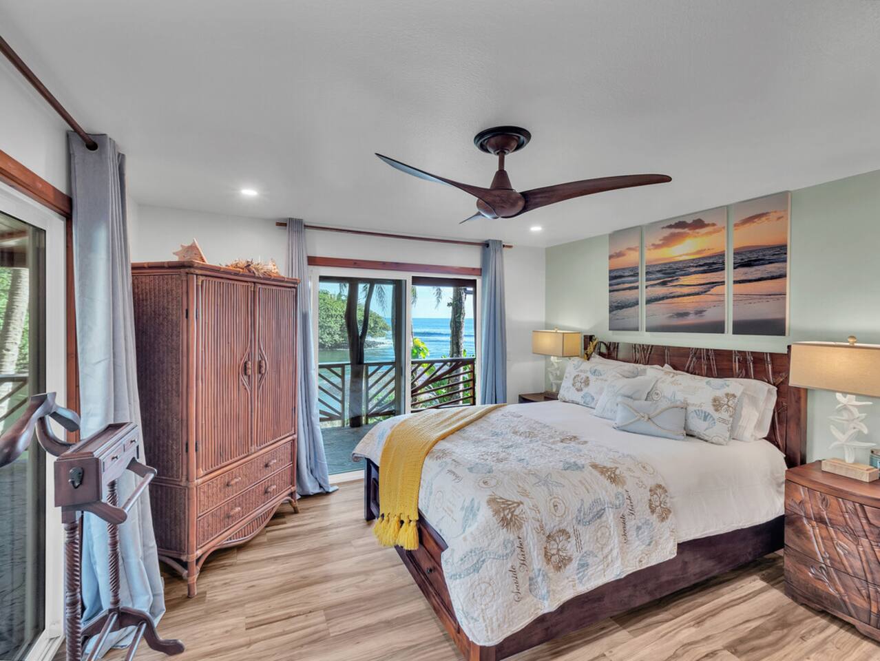 Wake up to the sound of the ocean in this main level master bedroom, featuring ocean views and elegant furnishings.