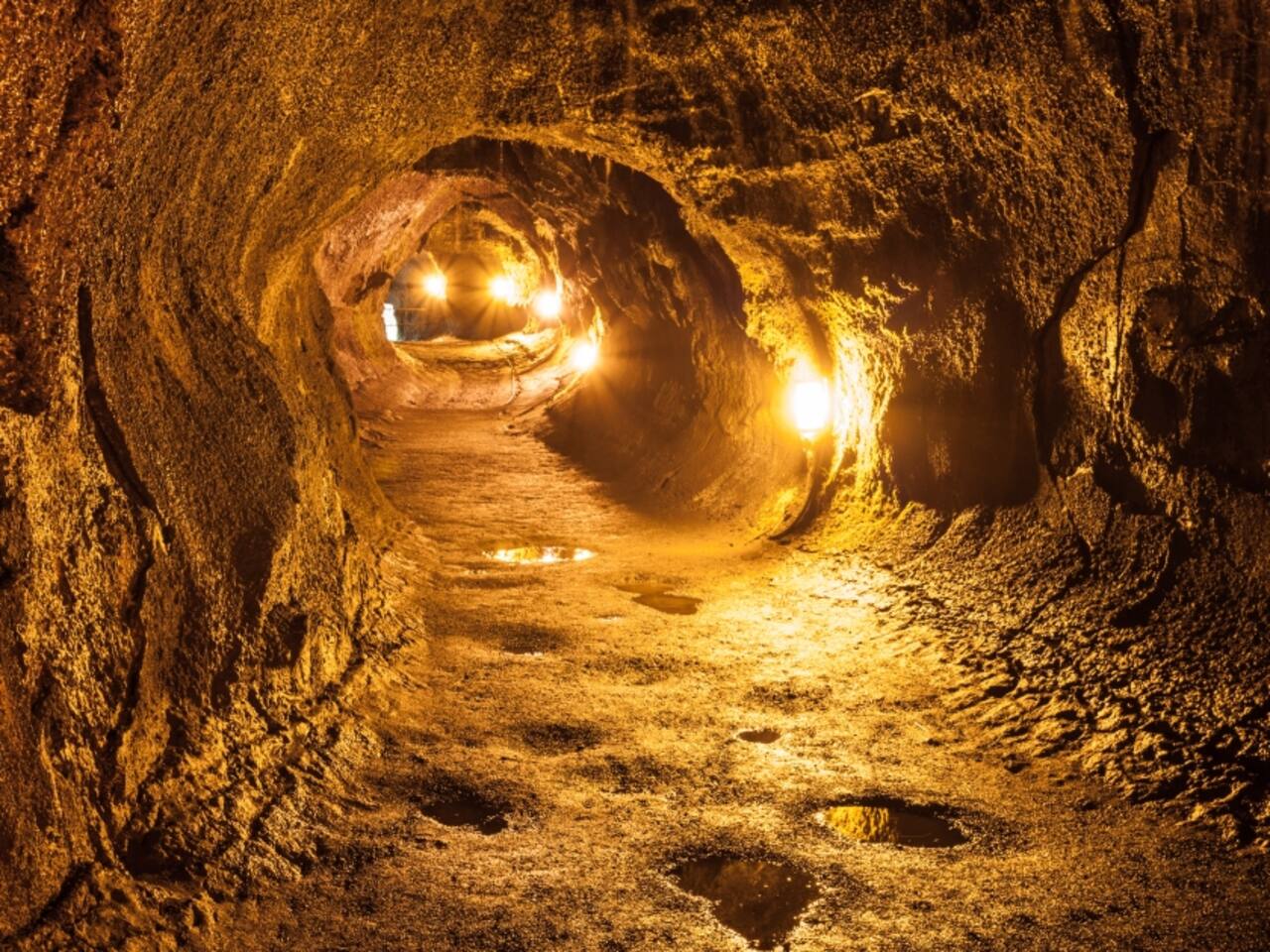 Explore the ancient lava tubes at Hawaii Volcanoes National Park, where you can walk through the tunnels carved by flowing lava millions of years ago