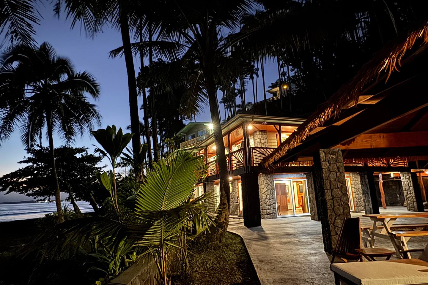 As the sun rises over the ocean, the soft glow of morning light brings a peaceful ambiance to this oceanfront paradise.