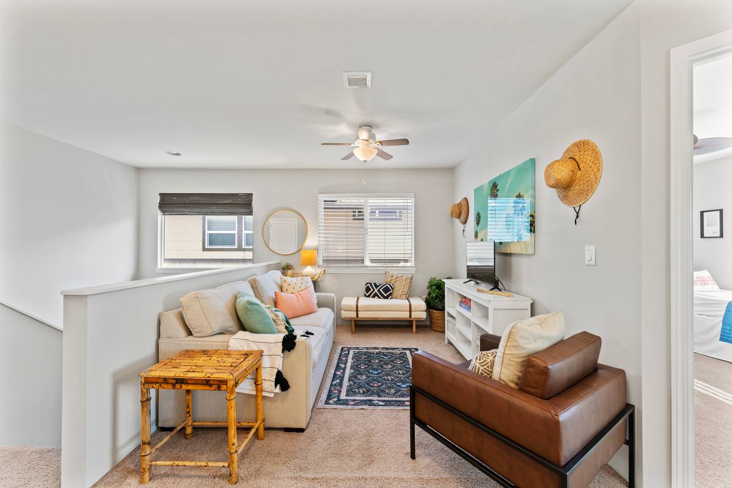 A cheerful blend of comfort and charm this living area is ideal for movie nights, morning coffee, or simply soaking in the sunshine through open windows.
