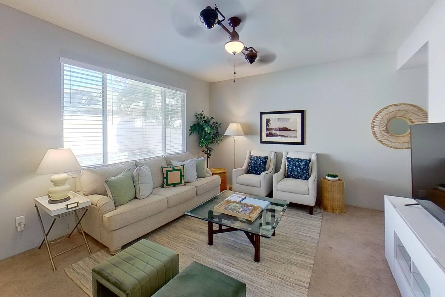 A bright and welcoming living room where soft seating, warm lighting, and tropical touches create the perfect space to relax and recharge.